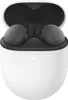 A pair of charcoal Google Pixel Buds A-Series are shown inside their white charging case. Produktbild-Vorschau