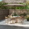 An outdoor patio scene with a table, chairs, and a large umbrella. Podgląd zdjęcia produktu