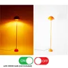 A split image showing a floor lamp on and off, with toggle switches below. Podgląd zdjęcia produktu