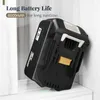 A black battery pack is leaning against a light-colored wall. Produktbild-Vorschau