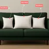 Three white pillows of different sizes are displayed on a dark green sofa, with labels indicating their dimensions. Produktbild-Vorschau