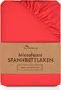A red fitted sheet with a brown paper band around it. Produktbild-Vorschau