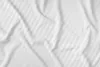 A close-up, top-down view of white satin bed linen with a subtle striped pattern. Produktbild-Vorschau