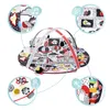 A baby play mat with arches and hanging toys, shown with close-up insets highlighting features. Podgląd zdjęcia produktu