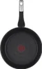 The bottom view of a black frying pan with a textured surface and a red logo in the center. Produktbild-Vorschau