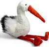 A plush toy stork sitting on a white background. Produktbild-Vorschau