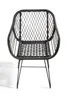 A black woven chair with metal legs on a white background. Produktbild-Vorschau