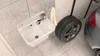 A sink and a car tire are shown in a garage or utility room setting. Anteprima dell’immagine prodotto