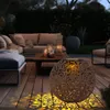 A decorative solar lantern on a wooden deck at night, casting patterned light. Produktbild-Vorschau