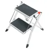 A white two-step folding stepladder with gray anti-slip treads and a red safety lock. Anteprima dell’immagine prodotto