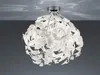 A white leaf-shaped ceiling light fixture is shown against a gray and white background. Anteprima dell’immagine prodotto