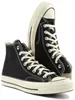 A pair of black high-top Converse Chuck 70 sneakers with white laces and soles, presented against a white background. Voir les images du produit