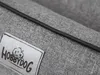 A close-up view of a grey fabric product with a black piping detail and a label. Produktbild-Vorschau