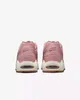 The back view of two pink Nike Air Max Command Premium sneakers against a white background. Voir les images du produit