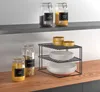 A kitchen shelf with jars of food and a tiered shelf organizer holding plates. Produktbild-Vorschau
