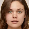 A close-up portrait of a young woman's face. Produktbild-Vorschau