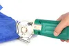 A hand is holding a green electric rotary cutter to cut a piece of blue fabric. Produktbild-Vorschau