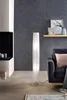 A modern living room with a floor lamp, sofa, and fireplace. Produktbild-Vorschau