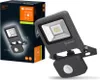 A product box and the floodlight it contains are displayed against a dark background. Produktbild-Vorschau