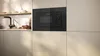 A built-in microwave oven is integrated into a modern kitchen cabinet. Anteprima dell’immagine prodotto