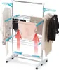 A multi-tiered electric clothes drying rack with clothes hanging on it. Red arrows indicate airflow. Voir les images du produit