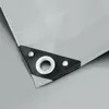 A close-up view of the corner of a gray tarp, showing a reinforced black corner with a metal grommet. Náhled obrázku produktu