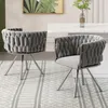 Two gray upholstered dining chairs with silver metal legs are shown in a dining room setting. Produktbild-Vorschau