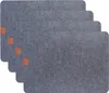A stack of four grey placemats with small brown accents. Produktbild-Vorschau