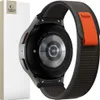 The back of a smartwatch with a nylon band, next to its packaging. Náhled obrázku produktu
