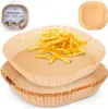 A stack of square parchment paper liners for an air fryer, with one liner filled with french fries. Podgląd zdjęcia produktu