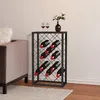 A modern black metal wine rack filled with wine bottles, placed next to a sofa and a vase with flowers on top, in a living room setting. Produktbild-Vorschau