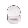 A stack of white ceramic bowls with a speckled design and a brown rim, isolated on a white background. Náhled obrázku produktu