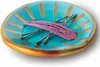 A small, decorative dish with hair clips inside. Produktbild-Vorschau