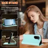 A woman is looking down at a table where a turquoise phone case is displayed, with two smaller images showing the phone case in use as a stand. Náhled obrázku produktu