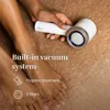 A person is holding an electric callus remover over a person's feet. Produktbild-Vorschau