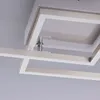 A close-up view of a modern ceiling light fixture with a geometric frame design. Produktbild-Vorschau