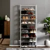 A multi-tiered shoe rack filled with various shoes, placed against a gray wall. Produktbild-Vorschau