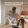 A man sits at a desk in front of a computer, using an ergonomic office chair. The chair is the main focus, with text overlayed on the image. Produktbild-Vorschau