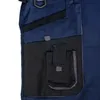 A close-up view of a dark blue work pant pocket. Produktbild-Vorschau