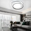 A modern living room with a sofa, coffee table, and a ceiling light. Náhľad obrázku produktu