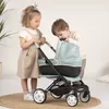 Two young children playing with a doll stroller. Produktbild-Vorschau