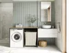 A modern laundry room or bathroom featuring a washing machine, sink, and storage. Produktbild-Vorschau