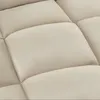 A close-up view of the quilted upholstery of a recliner or sofa. Náhled obrázku produktu