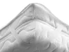 A close-up view of the corner of a white quilted mattress protector with elastic straps. Produktbild-Vorschau