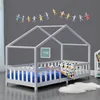 A child's house-shaped bed with bedding and a decorative garland on the wall. Náhled obrázku produktu