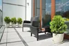 A balcony with two chairs, a small table, and several potted plants. Produktbild-Vorschau