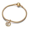 A gold Pandora bracelet with a charm is displayed on a white background. Voir les images du produit