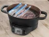 A cooking pot with three sealed bags of meat inside, sitting on a wooden surface. Podgląd zdjęcia produktu