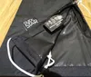 A close-up view of a black umbrella cover, showing a label with material information and care instructions. Produktbild-Vorschau