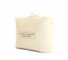 A cream-colored storage bag for bedding with a black logo on the front. Produktbild-Vorschau